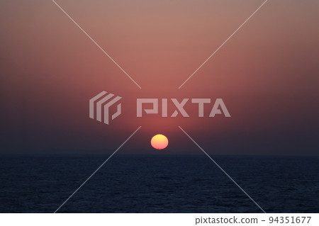 The day begins with the sunrise rising from the sea 94351677