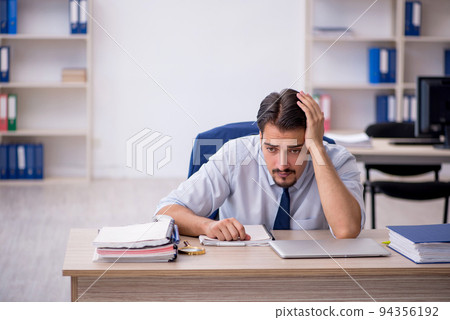 Young male employee working in the office 94356192