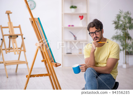 Young man enjoying painting at home Young man enjoying painting at home 94356285