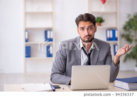Young male employee working in the office Young male employee working in the office 94356337