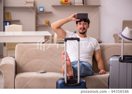 Young man preparing for trip at home 94356586