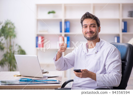 Young male doctor working in the clinic Young male doctor working in the clinic 94356594
