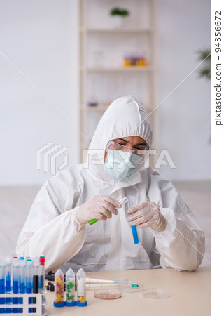 Young male chemist in drugs synthesis concept 94356672