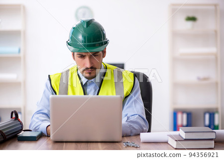 Young male architect working in the office Young male architect working in the office 94356921