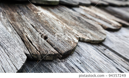 Close up view of texture dark colour old school wooden roof tiles Close up view of texture dark colour old school wooden roof tiles 94357249