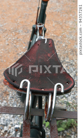 Broken rusty old and traditional bicycle seat Broken rusty old and traditional bicycle seat 94357261