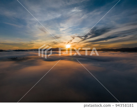 Aerial view drone flying over sea of fog at sunrise, Khoa Khai nui mountain, Phang Nga, Thailand. 94358181