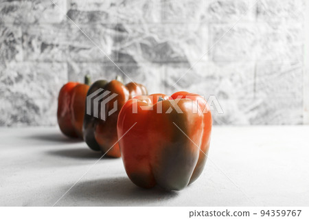 Colorful vegetables, yellow, green and red bell peppers on gray wall background Colorful vegetables, yellow, green and red bell peppers on gray wall background 94359767