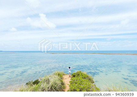 A trip to Okinawa Elementary school girl looking at the blue sea from Zane Beach 94360939