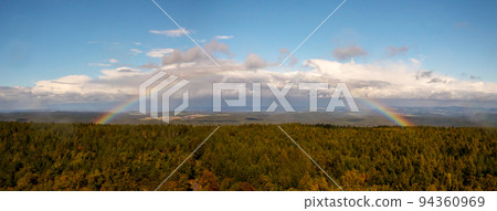 Rainbow over the forest - autumn landscape with rainbow Rainbow over the forest - autumn landscape with rainbow 94360969