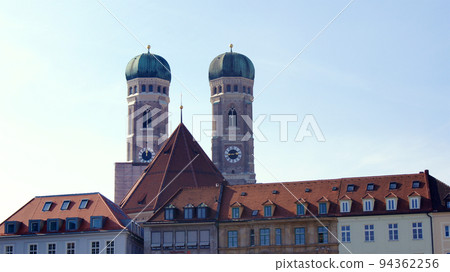 MUNICH, GERMANY - 12 OCT 2015: Towers or spires of the Frauenkirche in the city centre of Munich MUNICH, GERMANY - 12 OCT 2015: Towers or spires of the Frauenkirche in the city centre of Munich 94362256