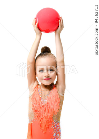 Small gymnastic girl hold rubber ball up Small gymnastic girl hold rubber ball up 94362713