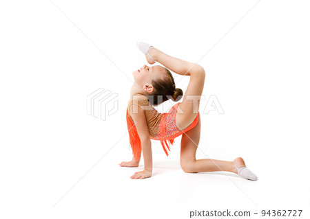 Flexible little gymnast stretching body in studio Flexible little gymnast stretching body in studio 94362727