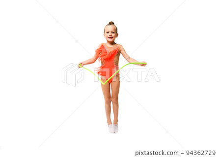 Little sporty gymnast girl jump with rope 94362729