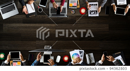 Top view of business Group of Multiethnic Busy People meeting with other in modern office with laptop computer, smartphone, tablet, coffee and document on table.. 94362803