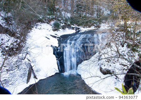 Beautiful nature of Hokkaido in the middle of winter Waterfall flowing in the valley 94363077
