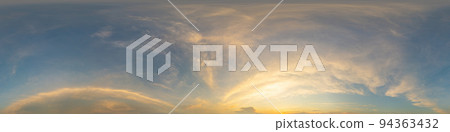 Golden glowing sunset sky panorama with Cirrus clouds. Hdr seamless spherical equirectangular 360 panorama. Sky dome or zenith for 3D visualization and sky replacement for aerial drone 360 panoramas. 94363432