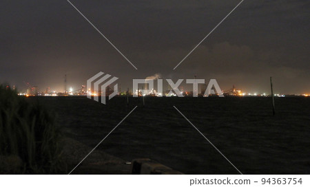 Factory night view seen across the sea Factory night view seen across the sea 94363754