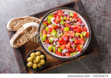 Summer in Mallorca salad Trampo is built on a base of tomato, green peppers and onions closeup on the wooden board. Horizontal top view Summer in Mallorca salad Trampo is built on a base of tomato, green peppers and onions closeup on the wooden board. Horizontal top view 94364674
