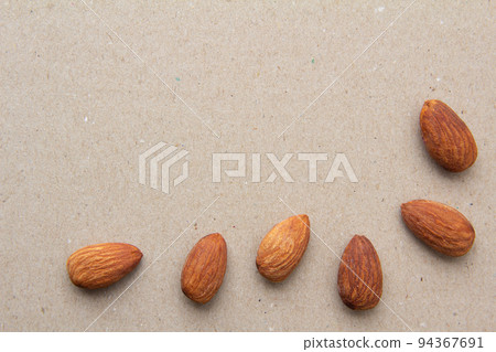 Almond and gray textured background and copy space arranged in an overhead view L shape 94367691