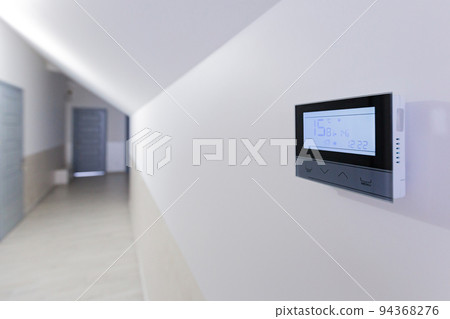 Control panel, air conditioning and heating system of the house, on a white wall, smart home Control panel, air conditioning and heating system of the house, on a white wall, smart home 94368276
