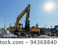 Heavy machinery and shining sun at the demolition site 94368840