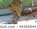 Small demolition machine that grabs steel scraps at the demolition site 94368844