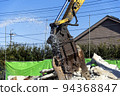 A demolition site where water is sprayed to reduce dust 94368847