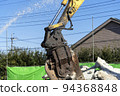 A demolition site where water is sprayed to reduce dust 94368848