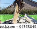 A demolition machine that lifts a demolished concrete slab 94368849