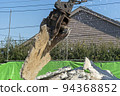 A demolition machine that lifts a demolished concrete slab 94368852