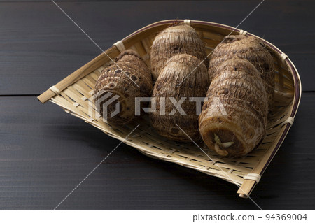 Satoimo on a colander _ background blackboard 94369004