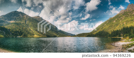 Tatra National Park, Poland. Famous Mountains Lake Morskie Oko Or Sea Eye Lake In Summer Morning. Beautiful Sunrise Sunrays Above Tatras Lake Landscape Tatra National Park, Poland. Famous Mountains Lake Morskie Oko Or Sea Eye Lake In Summer Morning. Beautiful Sunrise Sunrays Above Tatras Lake Landscape 94369226