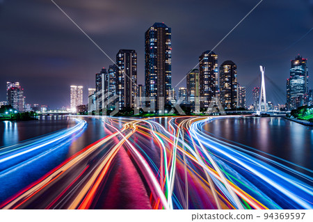 The night view of Tsukishima skyscrapers and the locus of houseboats seen from Eitai Bridge 94369597