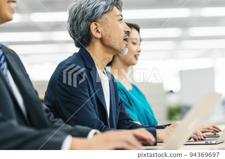 Middle business person listening at a meeting Middle business person listening at a meeting 94369697