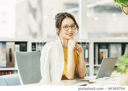 A woman working in a stylish office 94369704