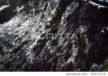 Rocks on the wall of the cave Black and white world Lava tunnel Rocks on the wall of the cave Black and white world Lava tunnel 94371114