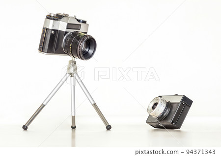 Two vintage cameras together. Big and little concept. Two vintage cameras together. Big and little concept. 94371343