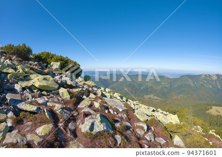 Rocky mountain hillside with big stone boulders on sunny day Rocky mountain hillside with big stone boulders on sunny day 94371601