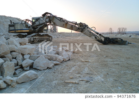 Open pit mining site of construction sand stone materials with excavator equipment for digging of gravel resources at quarry 94371676