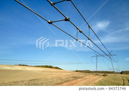 High voltage insulation string on steel pillar with electric power lines for safe delivering of electrical energy through cable wires on long distance High voltage insulation string on steel pillar with electric power lines for safe delivering of electrical energy through cable wires on long distance 94371746