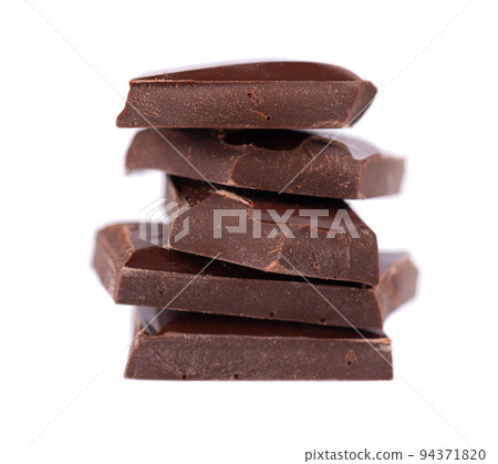 Chocolate pieces stack isolated on white background. Dark chocolate. Close up. 94371820