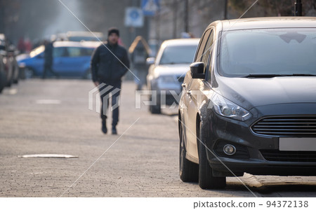 Close up of a car parked illegally against traffic rules on pedestrian city street side 94372138