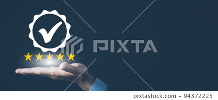 Quality assurance of business services, Businessman Hand shows the sign of the top service Quality assurance in Black background , Guarantee, Standards, ISO certification and standardization concept. 94372225