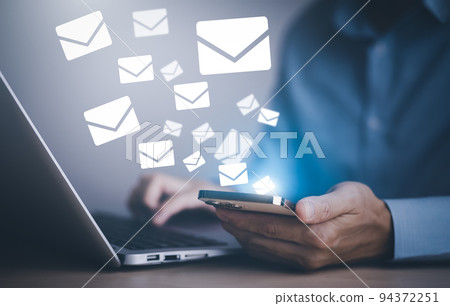 Businessman holding smartphone with communication icons, letter icon, email icons, and newsletter email and protect your personal information or spam mail, Customer service call center contact. 94372251