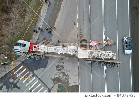 Aerial view of road accident with overturned truck blocking traffic 94372455