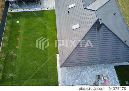Aerial view of residential house with backyard in suburban rural area 94372478