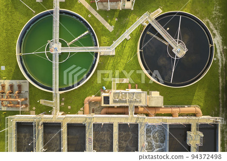Aerial view of modern water cleaning facility at urban wastewater treatment plant. Purification process of removing undesirable chemicals, suspended solids and gases from contaminated liquid 94372498