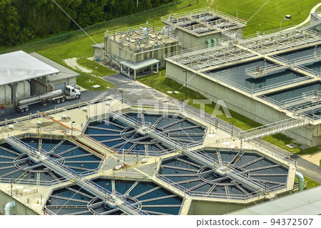 Aerial view of modern water cleaning facility at urban wastewater treatment plant. Purification process of removing undesirable chemicals, suspended solids and gases from contaminated liquid 94372507