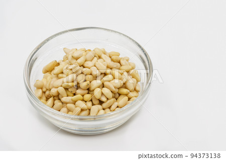 Pine nuts in a glass bowl closeup Pine nuts in a glass bowl closeup 94373138